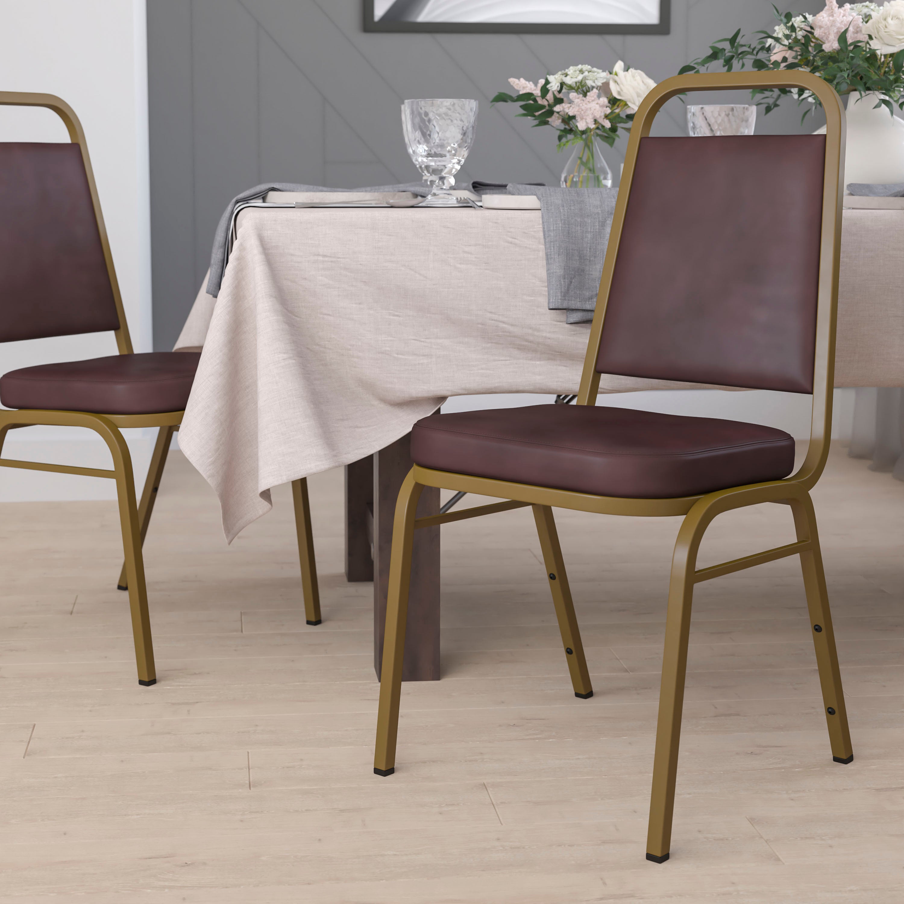 HERCULES Series Trapezoidal Back Stacking Banquet Chair in Brown Vinyl - Gold Frame