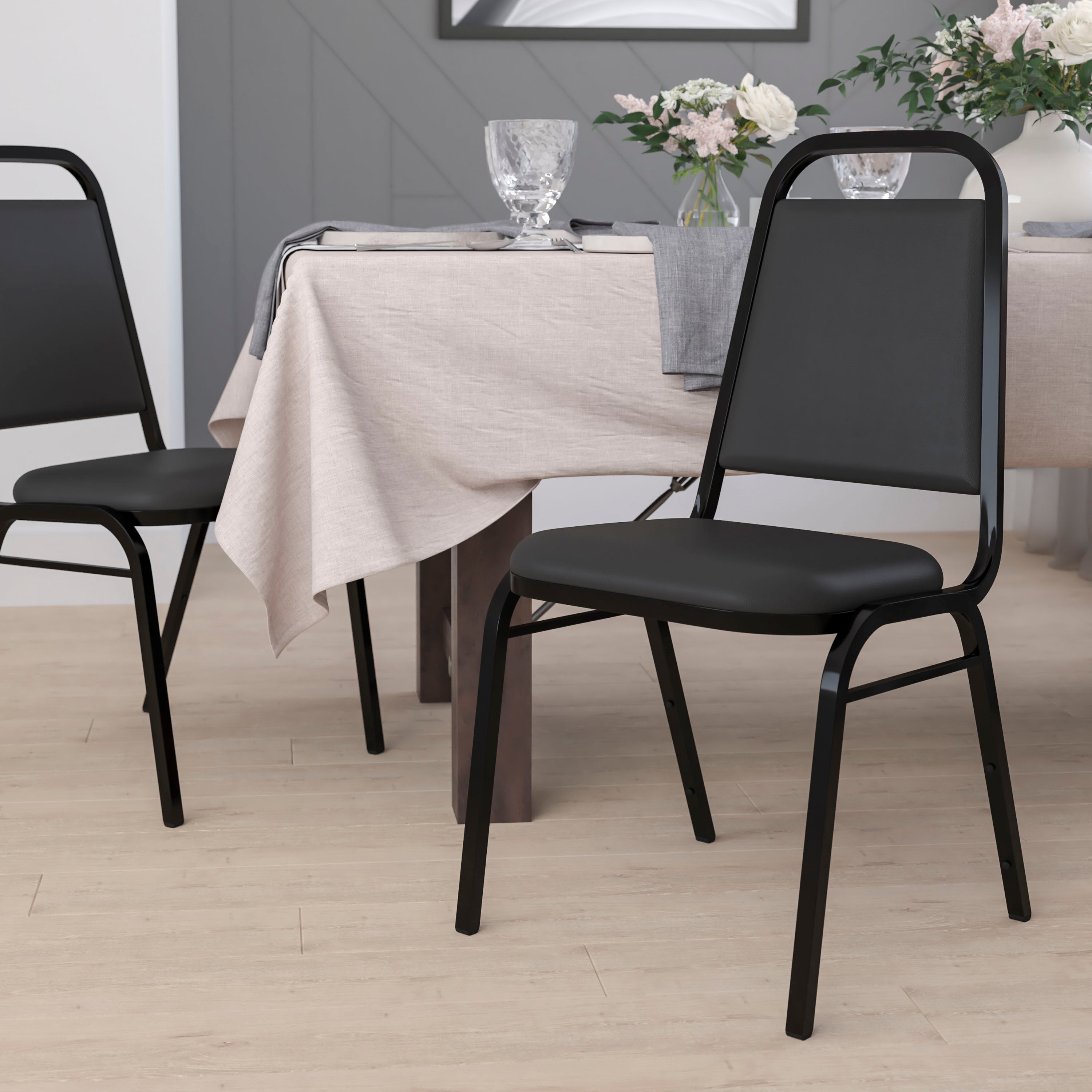 HERCULES Series Trapezoidal Back Stacking Banquet Chair in Black Vinyl - Black Frame