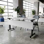 Palmer Commercial Grade 60" x 24" Heavy-Duty Nesting Flip Training Table with T-Legs, Modesty Panel, 1" Thick Gray Tabletop, and Black Steel Frame