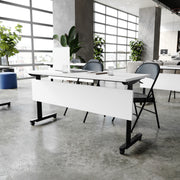 Palmer Commercial Grade 60" x 24" Heavy-Duty Nesting Flip Training Table with T-Legs, Modesty Panel, 1" Thick White Tabletop, and Black Steel Frame