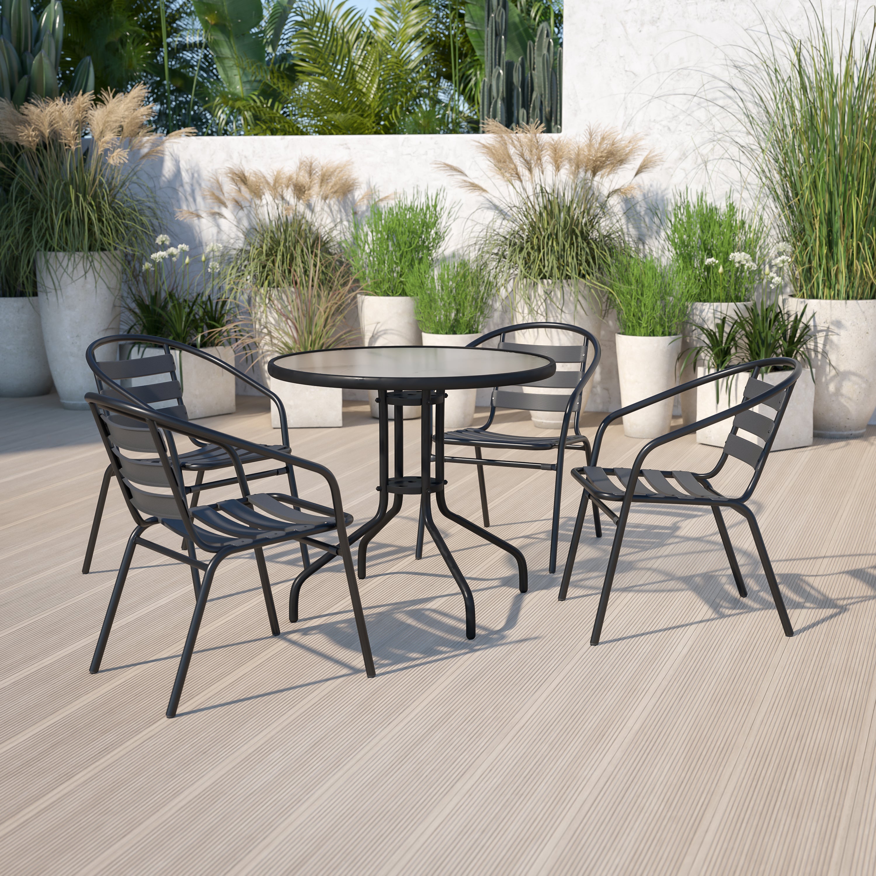 Lila 31.5'' Round Glass Metal Table with 4 Black Metal Aluminum Slat Stack Chairs