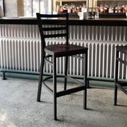 HERCULES Series Black Ladder Back Metal Restaurant Barstool - Walnut Wood Seat