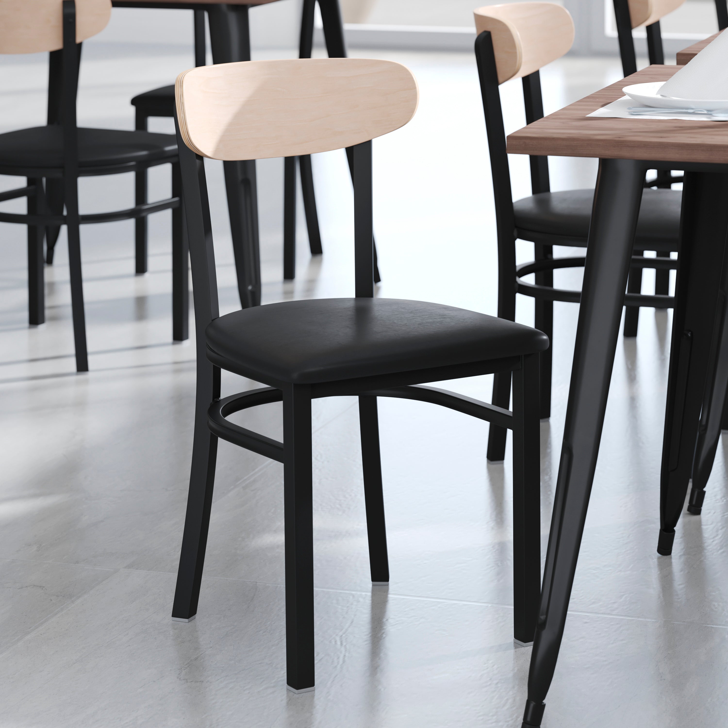 Wright Commercial Dining Chair with 500 LB. Capacity Black Steel Frame, Natural Birch Finish Wooden Boomerang Back, and Black Vinyl Seat