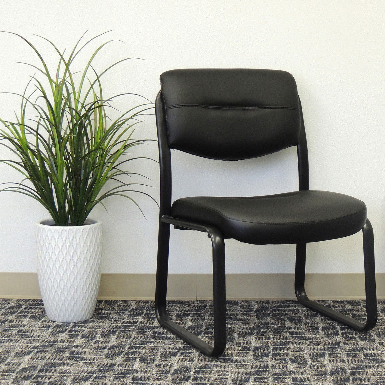 OfficeSource Merit Armless Sled Base Guest Chair with Black Frame - Black Leather Soft Vinyl