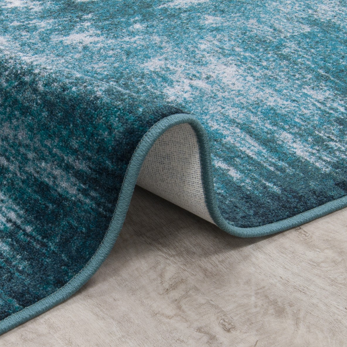 On The Edge 5'4" x 7'8" area rug in color Riviera